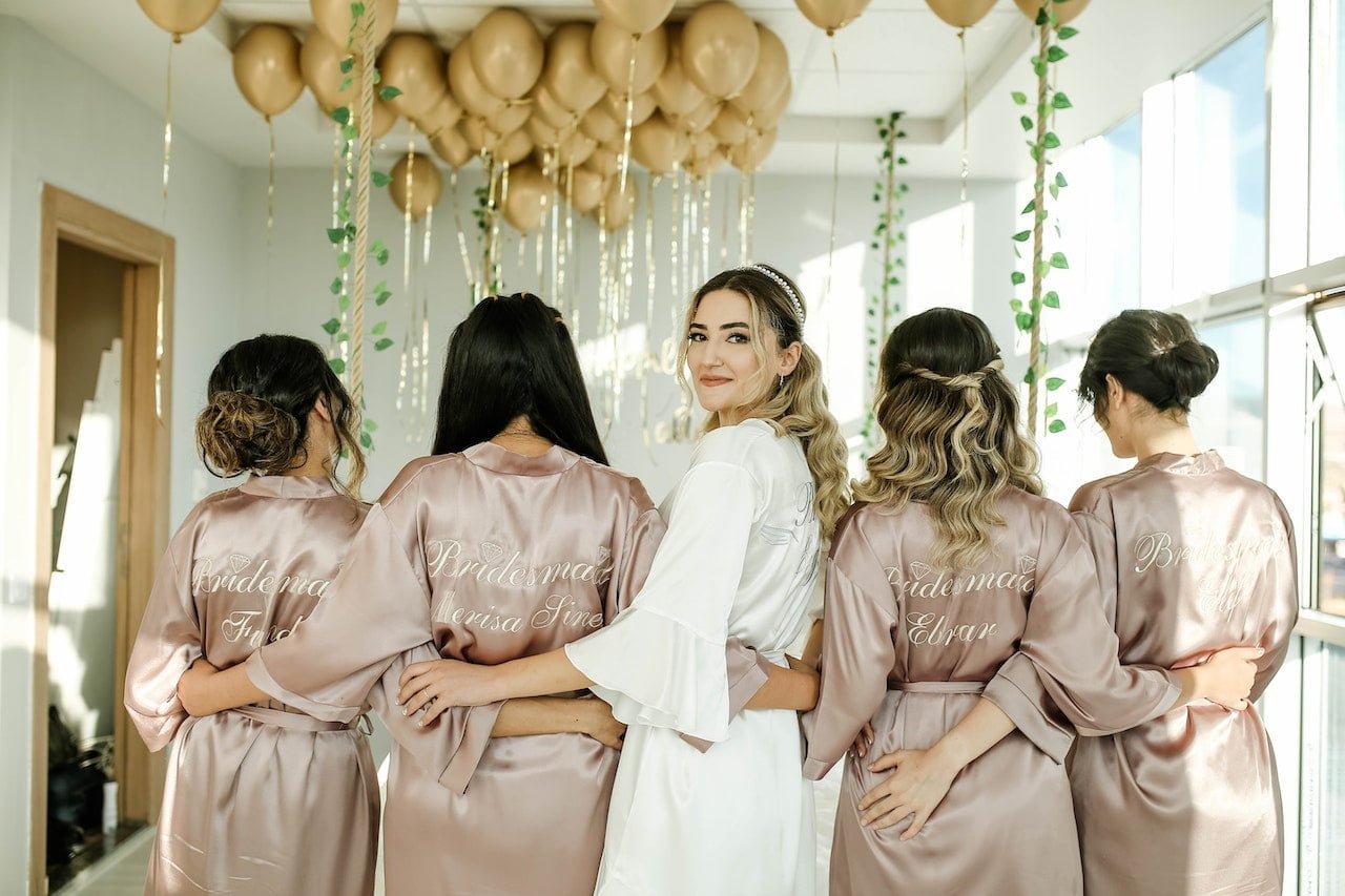 Bridesmaids in Neutral Robe Colours with Bride